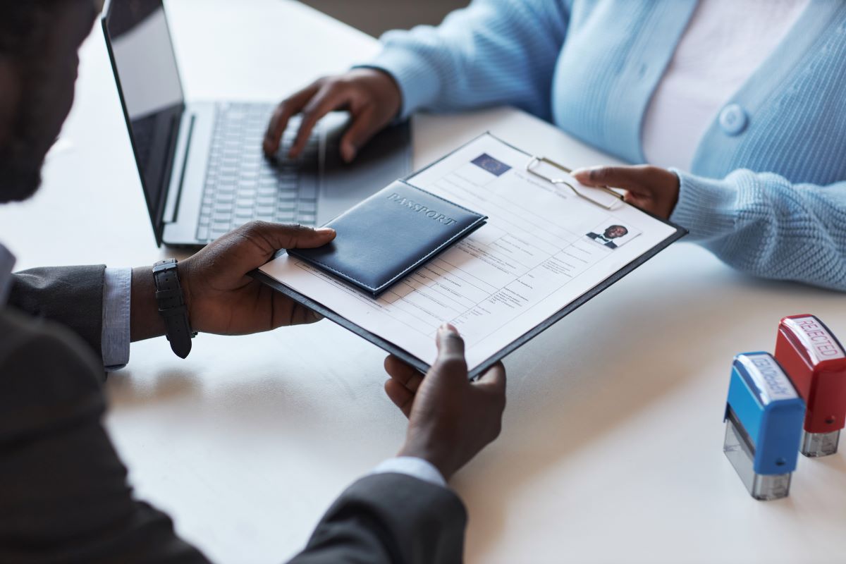 An investor hands over visa application documents